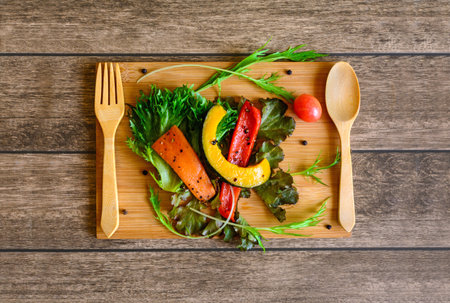 Ingredients of Fresh  salad on  wood cutting board with shadowの写真素材
