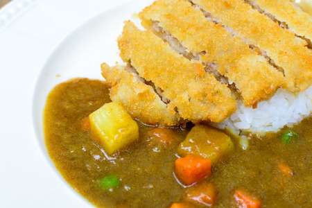 japanese curry and tonkatsu with rice on wooden tableの写真素材