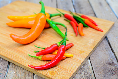 Various Red hot chili peppers on old wooden table