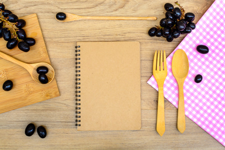 Food ingredient and kitchenware with notebook on wooden backgroundの写真素材