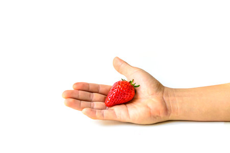 Fresh Strawberry on hand isolated on white backgroundの写真素材