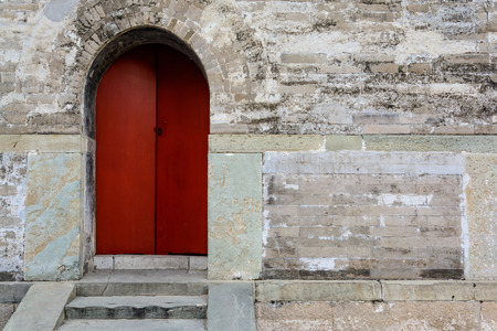 Ancient old wooden door with stone wallの写真素材