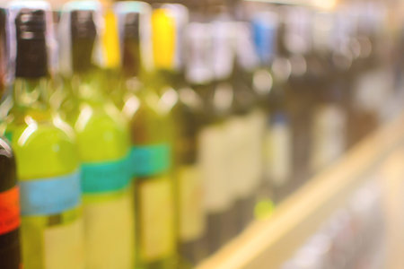Row of blurred wine bottles at shop