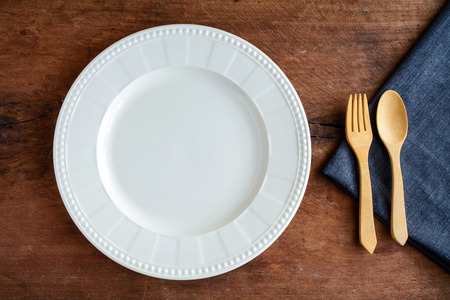 Empty dish with wooden spoon and fork on old wood, Top viewの写真素材