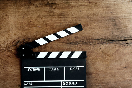 Movie clapper board on old wooden backgroundの写真素材