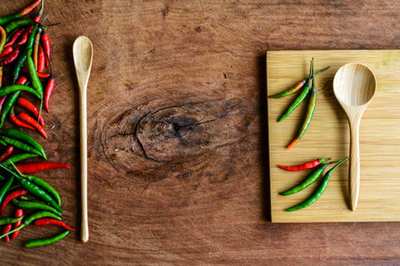 chilli pepper with wood cutting board on old wood backgroundの写真素材