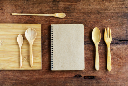 notebook and wooden utensil on old wood backgroundの写真素材