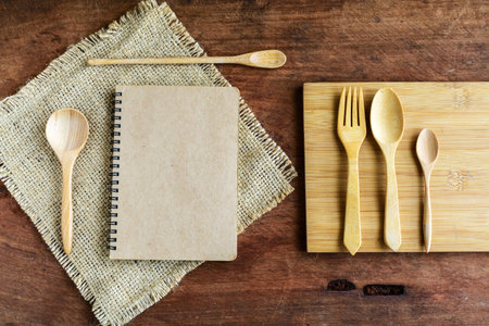 notebook and wooden utensil on old wood background
