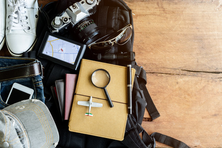 Outfit of traveler on old wooden background with soft lightの写真素材