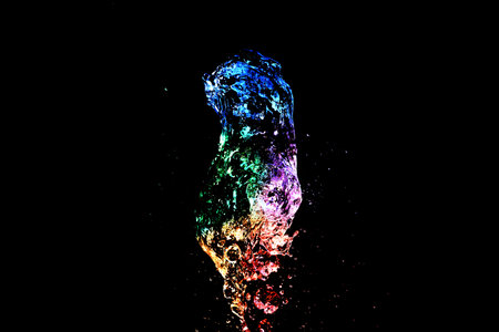 Abstract colorful Water splash isolated on black backgroundの写真素材