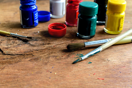 paintbrush and poster color on old wood tableの写真素材