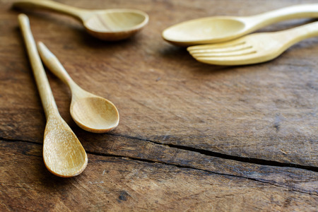 Close up of wood spoon and fork on old wooden tableの写真素材