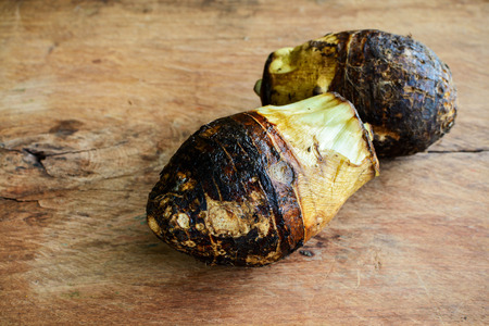 Close up of taro root on old wooden tableの写真素材