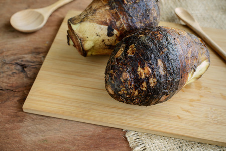 Close up of taro root on old wooden tableの写真素材