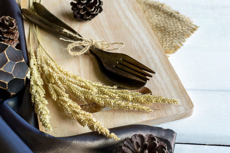 Decoration Seasonal table setting with wooden spoon and fork on white wooden table