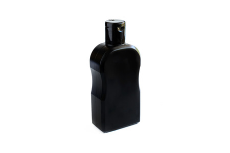 Black plastic bottle isolated on whiteの写真素材