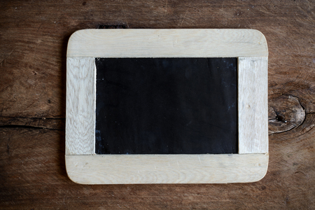 Empty chalkboard on old wooden backgroundの写真素材