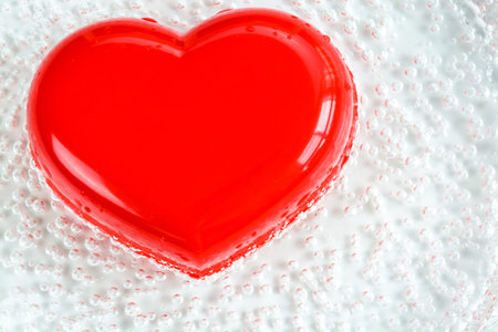 Red heart shape with bubble on white backgroundの写真素材