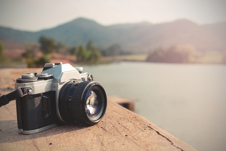 Vintage camera with view of lake and mountainの写真素材