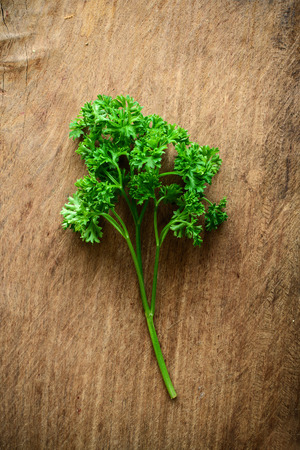 Bunch of parsley on a rustic wooden tableの写真素材