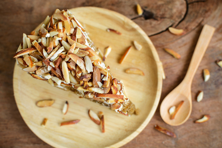 Coffee cake with almonds on top and cup of tea, Top viewの写真素材