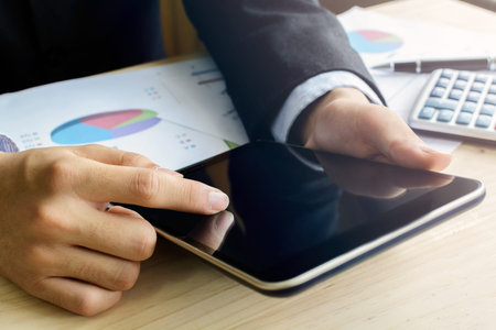 Close-up of business people working with touchpads on desk office