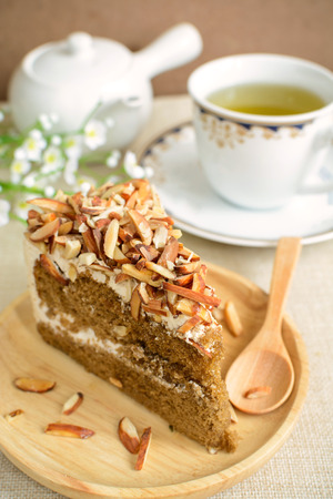 Coffee cake with almonds on top and cup of tea, Close upの写真素材