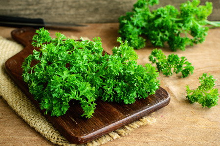 Bunch of parsley on a rustic wooden tableの写真素材