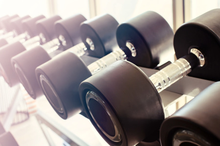 Close up row of dumbbells in modern sports club, Vintage toneの写真素材