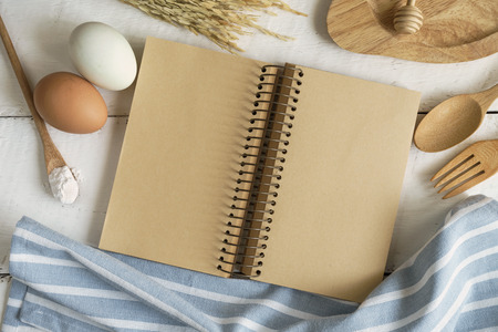 Open recipe book on white wooden table, Top viewの写真素材