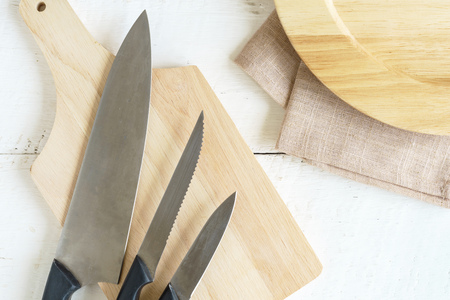 Set of kitchen knives on wooden cutting  board, top viewの写真素材