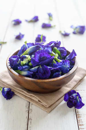 Butterfly pea or blue pea flower on white wooden tableの写真素材