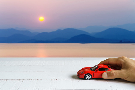 Car in hand and landscape background, Travel conceptの写真素材