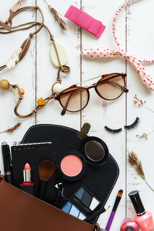 various makeup products and accessories on white wooden backgroundの写真素材