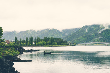 Lake kawaguchiko with cloudy on mountain  in japan, Vintage toneの写真素材