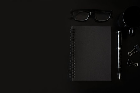 Black notebook with copyspace and cup of coffee