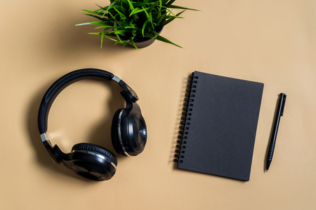 Black notebook with copyspace and headphone on deskの写真素材