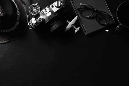 Retro camera with black notebook on black background and copy space, Top viewの写真素材