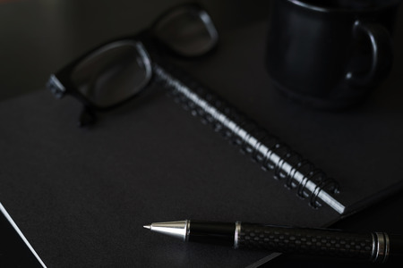 Black notebook with copyspace and cup of coffeeの写真素材