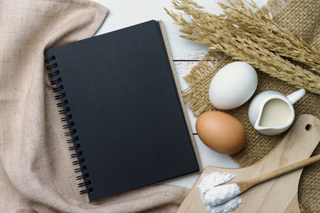Open recipe book on wooden table with copy space, Top viewの写真素材