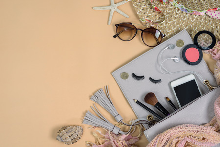 Fashion woman essentials, cosmetics, cellphone, makeup accessories isolated on colorful background, Top viewの写真素材