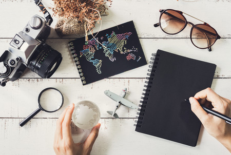 Overhead view of Traveler's accessories and items with black notebook and copy space, Travel conceptの写真素材