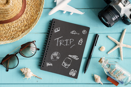 Overhead view of Traveler's accessories and items with copy space on wooden background, Travel conceptの写真素材