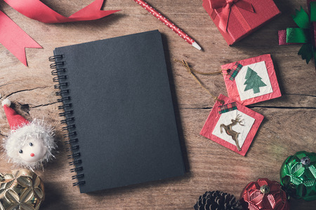 Blank notebook on old wooden background with decorations, Christmas themeの写真素材