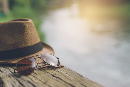 Hat and sunglasses with lake view, Travel conceptの写真素材