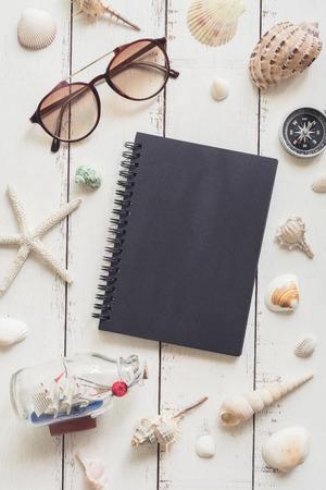sail boat toy model and shell on white wooden background, Travel conceptの写真素材
