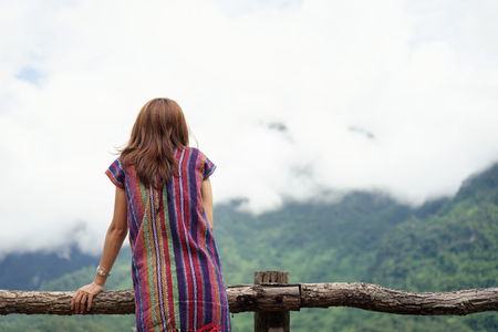 Woman traveler looking fog on the mountain, Vintage toneの写真素材