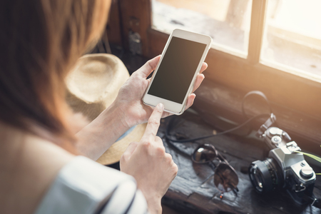 Young women traveller using smartphone and cameraの写真素材