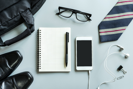 Blank notebook with cellphone desk office in workspace with copy space, Top viewの写真素材