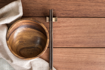 Wooden bowl with chopsticks on wooden table and copy space, Top viewの写真素材